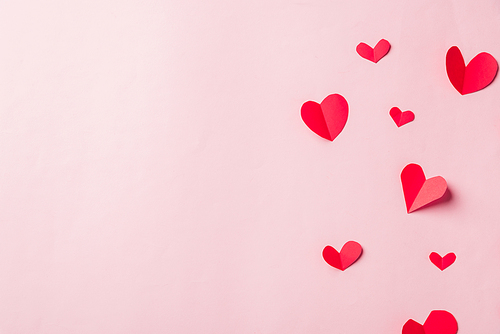 Valentines' day background. Pattern beautiful red paper hearts cut composition greeting gift card isolated on pink background with copy space, Symbol of love Top View from above