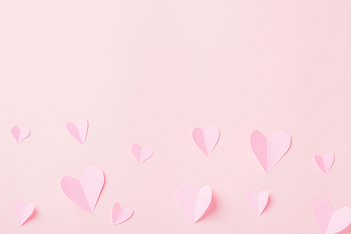 Valentines' day background. Pattern beautiful pink paper hearts cut composition greeting gift card isolated on pink background with copy space, Symbol of love Top View from above