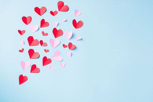 Valentines' day background. Pattern beautiful red paper hearts cut composition greeting card isolated on blue background with copy space, Symbol of love Top View from above