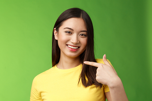 Close-up joyful proud asian assertive girl introduce herself, pointing own face smiling joyfully, boastful telling own achievement, bragging accomplishment, assure can deal with work.