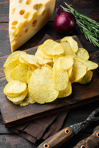 Home made potato chips set with Cheese and Onion, on old dark  wooden table