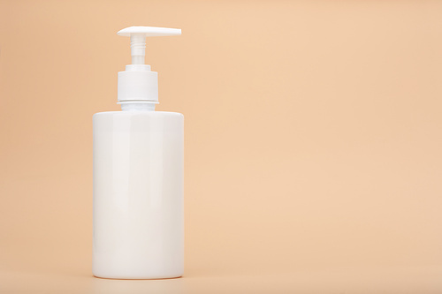 Shower gel, liquid soap or intimate gel in white unbranded tube against light beige background with copy space. Concept of intimate hygiene or gel for sensitive skin