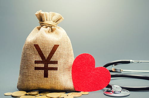 Yen Yuan money bag and stethoscope. Health life insurance financing concept. Funding healthcare system. Reforming and preparing for new challenges. Development, modernization. Subsidies, investments