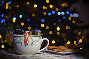 Conceptual Tea Cup Wearing Glasses On Candy Cane Nose with Holidays Bokeh Lights