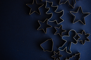 Christmas flat lay made with cookies cutters on deep blue background