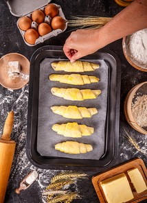 Sprinkling salt over homemade croissaints