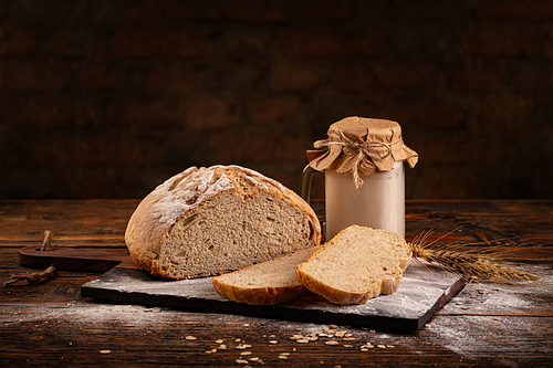 Crusty fresh homemade sourdough bread on wooden table