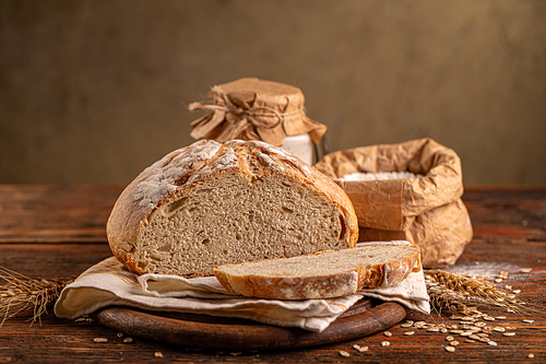 Loaf of a sourdough bread on rustic background