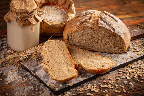 Wheat sourdough in glass jars and flour for baking homemade bread