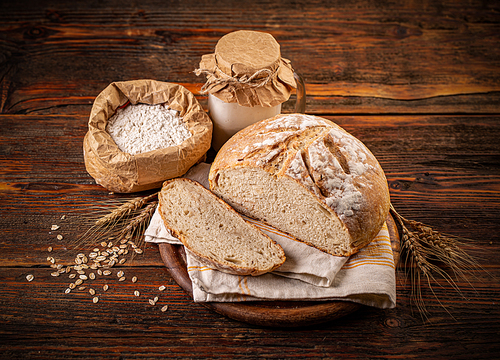 Rustic sourdough bread on wooden background