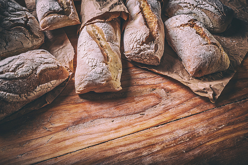 Lots of different bread sorts on wood background