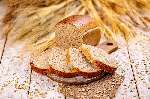 Wholegrain sliced organic bread composed of oats on wooden table. Healthy bread concept