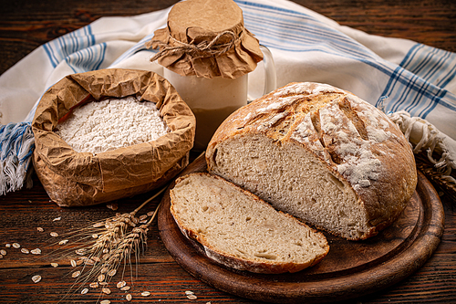 Loaf of a sourdough bread on rustic background