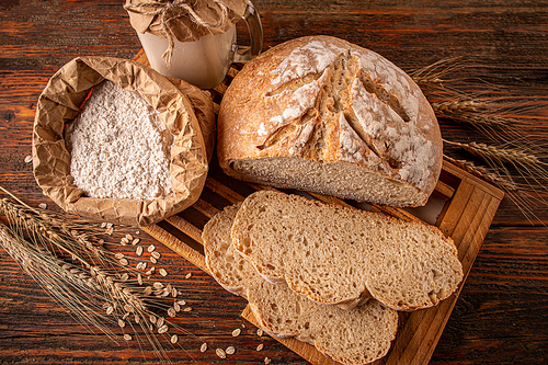 Crusty fresh homemade sourdough bread on wooden table