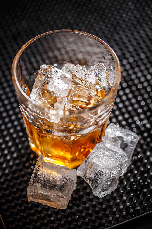 Glass of scotch whiskey with ice cubes