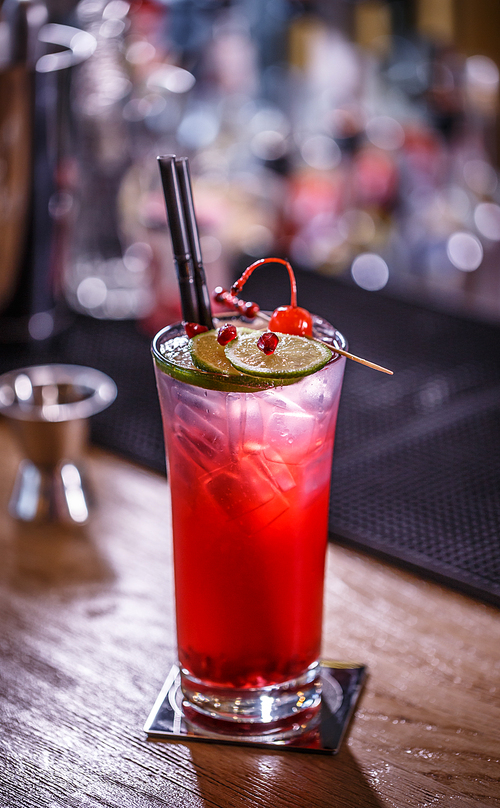 Non-alcoholic pomegranate cocktail with ice served with a straw