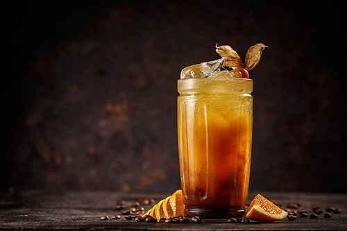 Orange and coffee cocktail on vintage dark background