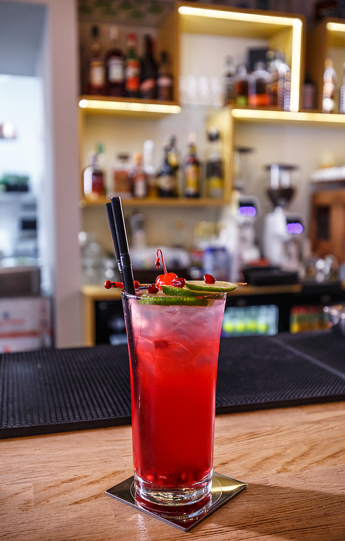 Fancy non-alcoholic pomegranate cocktail served on the bar counter