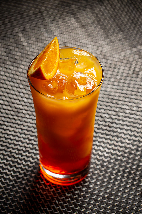 Chilled tropical aperol orange cocktail on a dark background