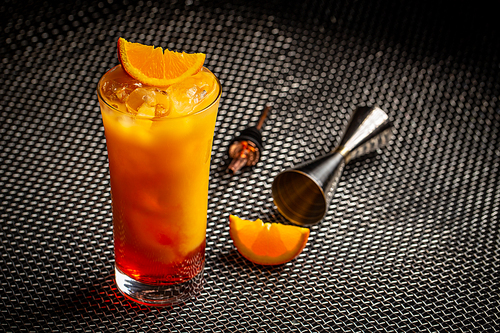 Classic italian aperol orange cocktail in glass on dark background