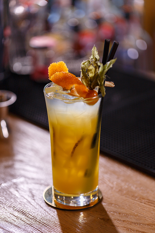 Fresh cocktail with orange and ginger served on the bar counter