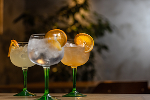 Three glass of gin and tonic cocktail on bar counter