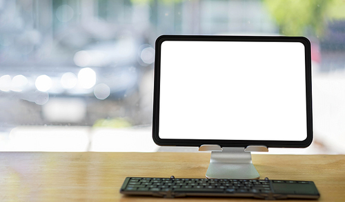 Blank screen Laptop computer and poster workspace background in modern office