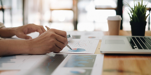 Close Up Of A Businessman Holding Graph Paper And Pen