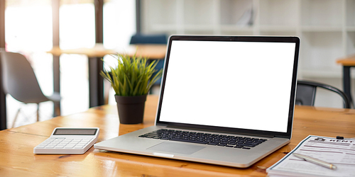 Blank screen Laptop computer and poster workspace background in modern office