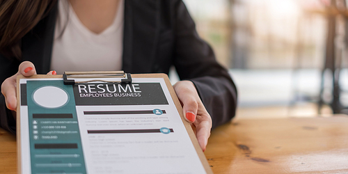 Businesswoman submits resume employer to review job application information on the desk, presents the ability for the company to agree with the position of the job.