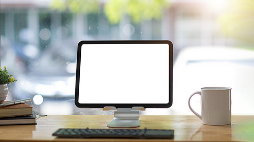 Blank screen Laptop computer and poster workspace background in modern office