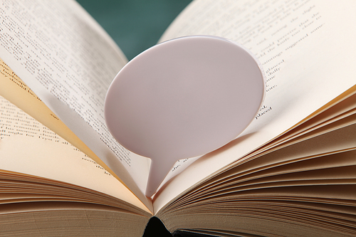 speech bubble resting on the open book