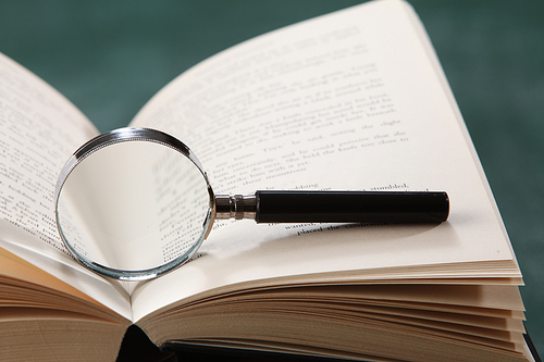 Magnifying glass resting on the book