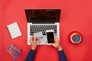 Man working at desk and purchasing products online, online shopping concept