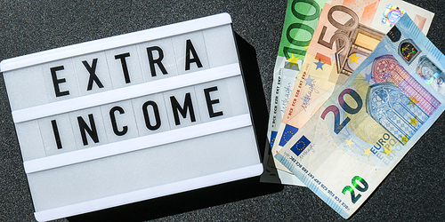 Lightbox board with word EXTRA INCOME in black letters around euro banknotes. Money, Business, finance, investment, saving. Cash bill. Business budget of wealth and prosperity finance. Passive income