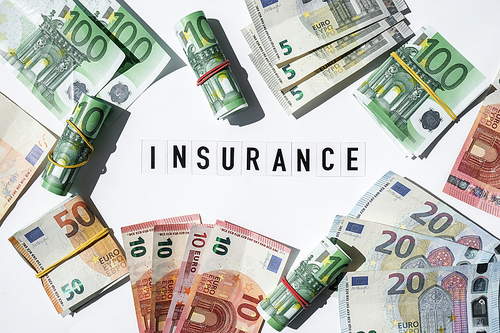 Text INSURANCE around Euro banknotes. Health, life, home, car Insurance. Insurance business concept. Business budget of wealth and prosperity finance. Health care or medicare insurance and vaccination costs. Financial crisis. Covid-19 crimes