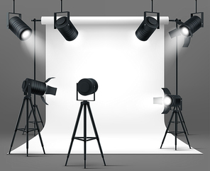 Photography studio interior with spotlights and white paper background. Vector realistic mockup of professional photo equipment in empty room, glowing floodlights on tripod and hanging