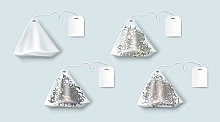 Tea bags with green and black leaves and herbs. Vector realistic set of transparent triangle teabags with blank white tag on string. Empty 3d sachet isolated on blue