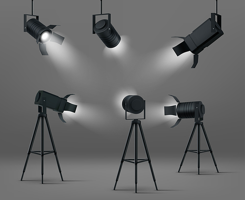 Spotlights for studio or stage. Vector realistic set of glowing floodlights for illumination show, concert or podium. Black spot lamps on stand and hanging on gray background