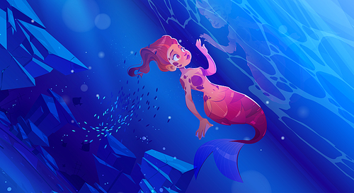 Cute girl mermaid under water in sea. Vector cartoon underwater landscape with beautiful woman fish with red hair and tail, school of fish and stones on ocean bottom