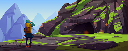 Woman hiker walks to cave in mountain. Vector cartoon illustration of summer landscape with rocks, stone cavern entrance, green grass and girl tourist with stick and backpack