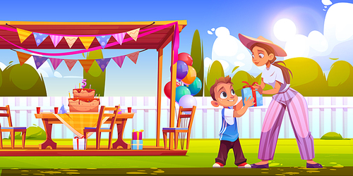 Birthday party on backyard with woman gives gift box boy. Vector cartoon illustration of garden with festive decoration, wooden tent, cake with candles, balloons and happy child