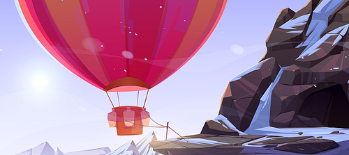 Hot air balloon tied near cave in mountains. Vector cartoon illustration of winter rocks landscape with stone cavern, snow and colorful airship with basket and ballast