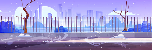 Winter city street with metal fence, bare trees and snowflakes flying in air. Cartoon vector illustration of urban buildings skyline and frosty snowy weather. Empty public garden landscape, dull sky