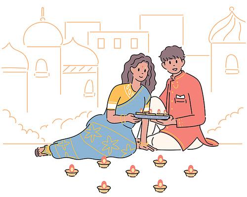 인도 커플이 촛불을 들고 기도를 하고 있다.