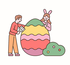 소년과 소녀가 부활절 달걀을 색칠하고 있다.