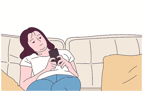 한 소녀가 소파에 늘어지게 앉아 휴대폰을 보고 있다 .