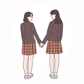 두 여학생이 손을 잡고 서로를 바라보고 있다