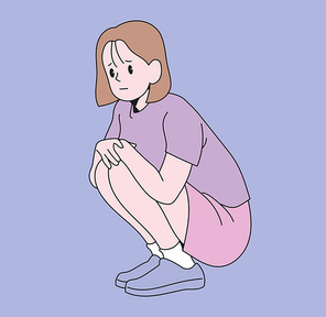 한 소녀가 심각한 표정으로 쪼그려 앉아 있다.