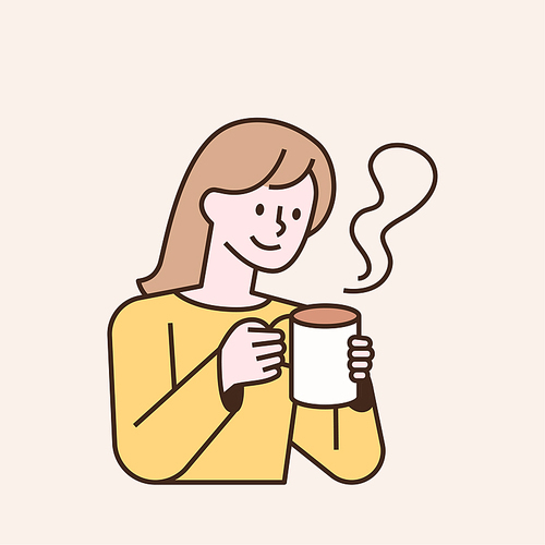 한 여성이 뜨거운 커피를 들고 있다.